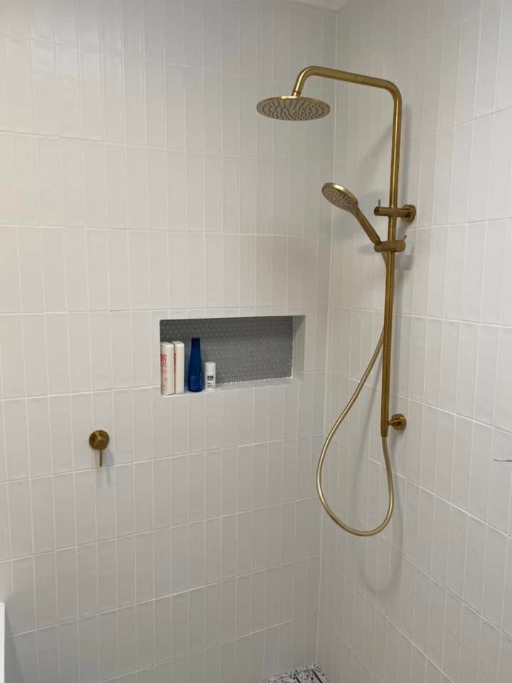 Brass shower fittings in a renovated bathroom